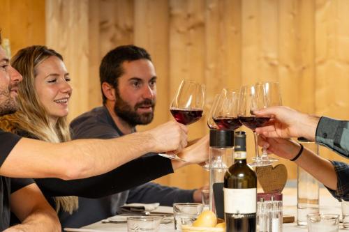 a group of people holding up glasses of wine at Hotel Nevada in Bormio