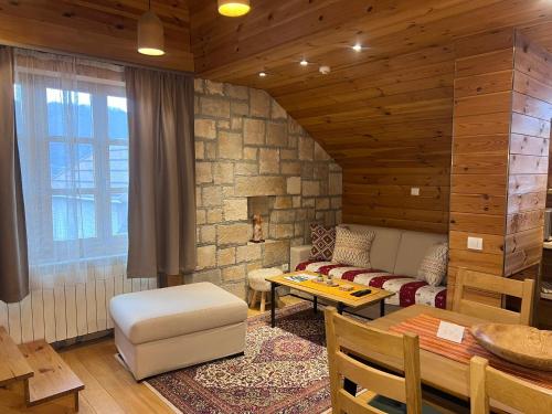 a living room with a couch and a table at Chalet Kolašin in Kolašin