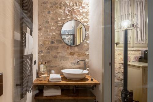 a bathroom with a sink and a mirror at Borgo Antichi Orti Assisi in Assisi