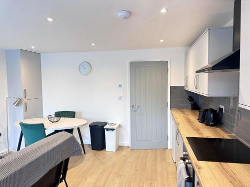 a kitchen with a table and a counter top at All Inn Apartments in Staveley