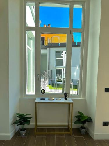 a room with a table in front of a window at Apt Pisces - Oasi di Menaggio in Menaggio
