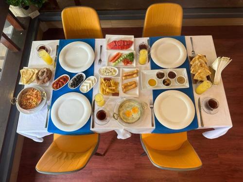 a table with plates and bowls of food on it at GP House Phuket Patong Beach in Patong Beach