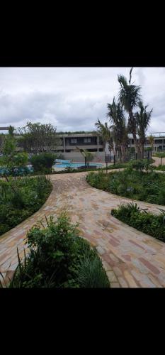 a brick walk way with a building in the background at PEBBLE BEACH SIBAYA in Umhlanga