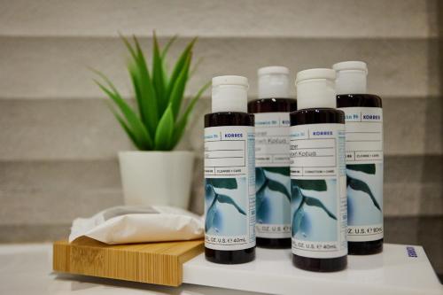 a group of four bottles of liquid sitting on a counter at Vasilicari Apartments in Chios