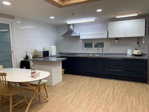 a large kitchen with a table and a counter top at On Dang in Gyeongju