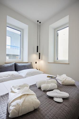 a bedroom with two beds with towels on the floor at Vasilicari Apartments in Chios