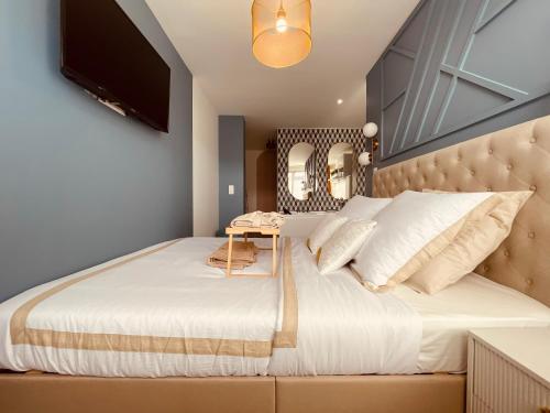 a bedroom with a large bed and a mirror at La balnéo de l'impératrice Anastasia - 306 in Rouen