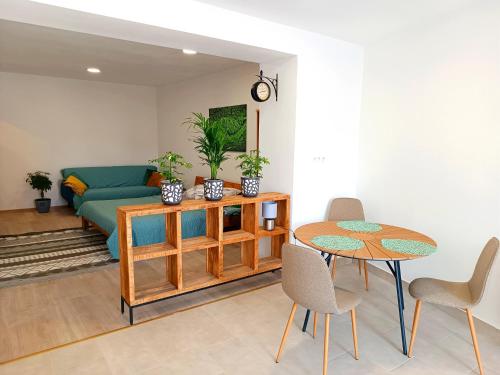 a living room with a table and a couch at Gasthaus Tauchen Family Apartment in Mönichkirchen