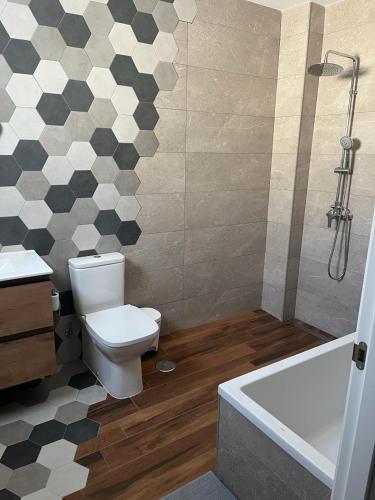 a bathroom with a toilet and a bath tub at El Balcón in Algodonales