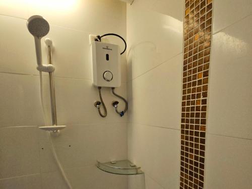 baño pequeño con ducha y teléfono en la pared en AppleOne CondoTower1-1055 en Cebu City