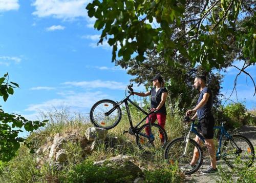 two people standing with bikes on a trail at DM-Discover Margarites Home in Margarítai
