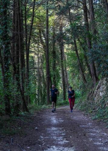 two people walking down a dirt road in a forest at DM-Discover Margarites Home in Margarítai
