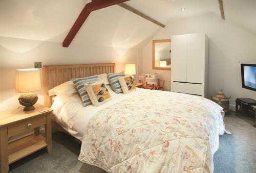 1 dormitorio con 1 cama grande y TV en The Maltings en Trunch