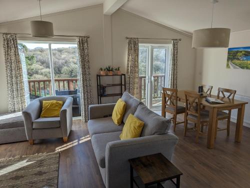 a living room with a couch and a table at Two Bedroom Lodge In The Country - Oak, Stag, Acorn in Liskeard
