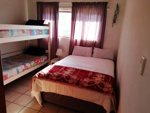 a bedroom with two bunk beds and a window at Saint Michael's Sandcastles in Margate