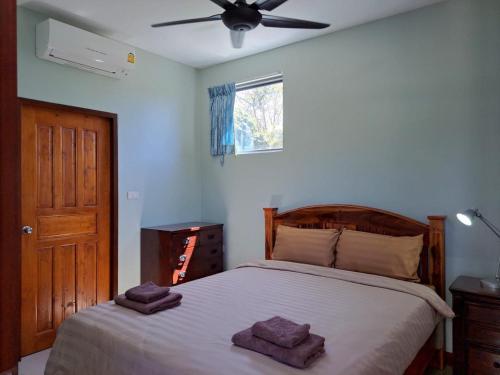 a bedroom with a bed with two towels on it at Seaview Eagles Nest Apartment 2 in Rawai Beach