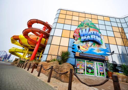 a water park with a water slide in front of a building at The Blenheim Mount Hotel in Blackpool