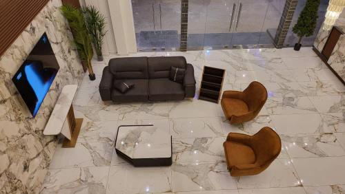 an overhead view of a living room with a couch and chairs at LIA hotel- Lungi International Airport in Tulun