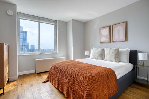 a bedroom with a large bed and a large window at Blueground Midtown West gym wd nr museum NYC-1452 in New York