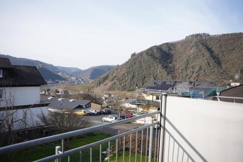 a view from a balcony of a town with a mountain at Ferienhaus Am Reilsbach in Cochem