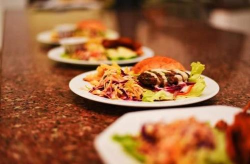 a row of plates of food on a table at Plaza Beach Hotel in Bamburi