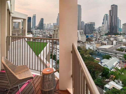 a balcony with a view of a city at Mercure Bangkok Surawong in Bangkok