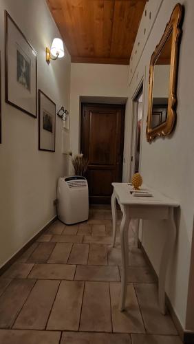 a hallway with a table and a mirror on the wall at Dal Podestà in San Gemini