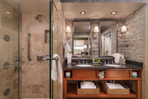 a bathroom with two sinks and a shower at Hilton Lexington Downtown in Lexington
