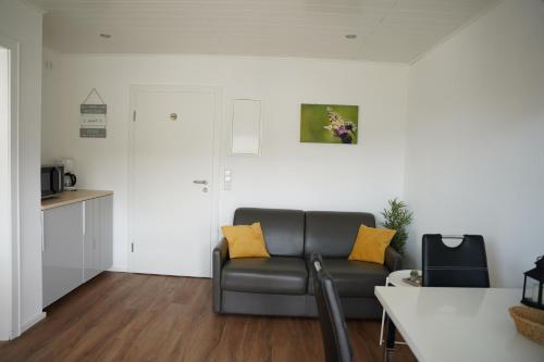 a living room with a couch and a table at Ferienhaus Am Reilsbach in Cochem