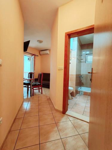 a hallway with a bathroom with a table and a toilet at Apartments Draženka in Neum