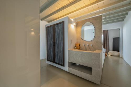 a bathroom with a sink and a mirror at Mykonos Rocks Villas & Suites in Mikonos