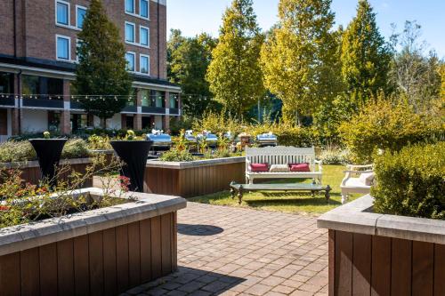 a garden with a bench and some plants at Hilton London Heathrow Airport Terminal 5 in Hillingdon