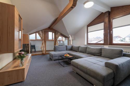 a living room with a couch and a tv at Gästehaus Köpf in Füssen