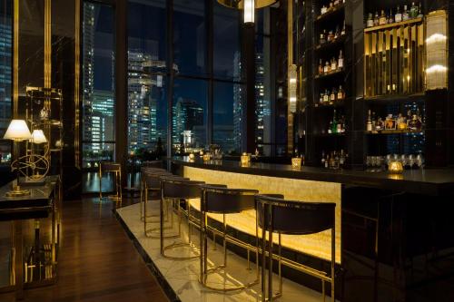 a bar with a view of the city at night at Hilton Yokohama in Yokohama