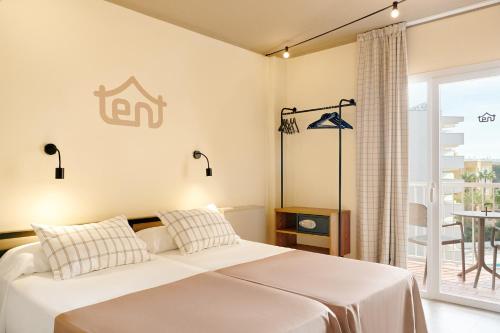 a hotel room with a bed and a window at tent Palmanova in Palmanova