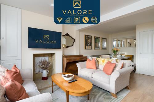 a living room with two couches and a table at Beautiful cottage style 3-bed By Valore Property Services in Loughton