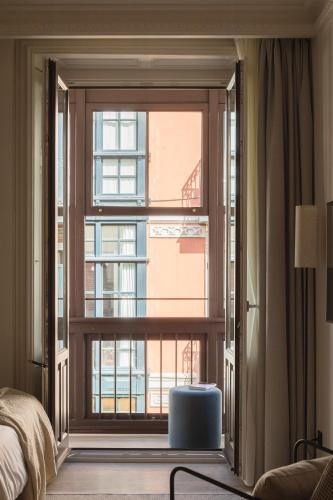 a bedroom with a large window with a view at Líbere Bilbao Ledesma in Bilbao