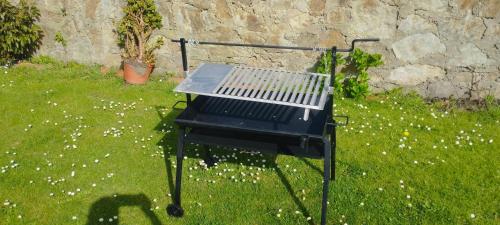 a barbecue grill sitting on the grass in a yard at Mar del Norte in Salamir
