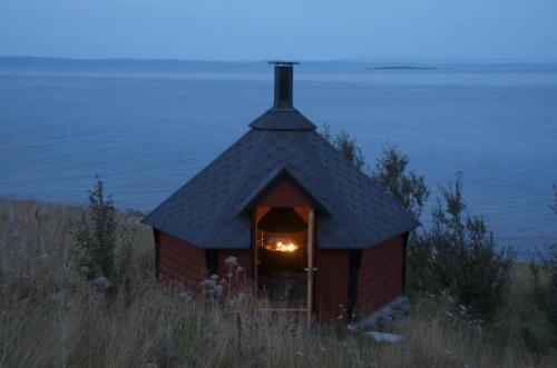 a small house with a light in the doorway at Seljenes Cottage in Russenes