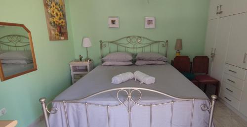 a bedroom with a large bed with two pillows at Art Deco Apartment in Athens