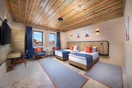 a hotel room with two beds and a couch at Breeze Of Cappadocia in Uchisar