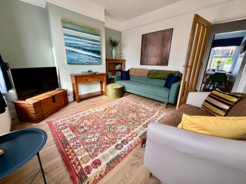 a living room with a couch and a tv at 3 bed terrace in central Cromer, close to beach in Cromer