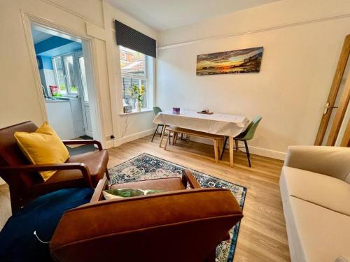 a living room with a couch and a table at 3 bed terrace in central Cromer, close to beach in Cromer