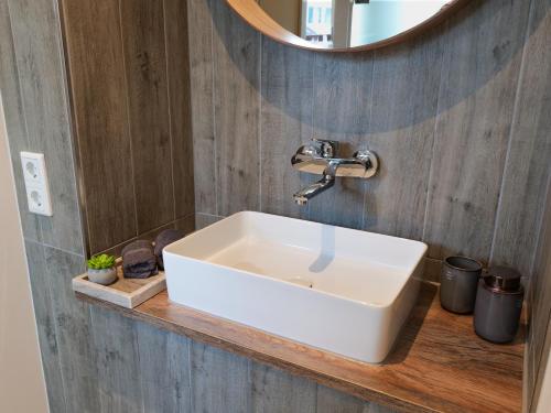a white sink in a bathroom with a mirror at Haus Boutique in Bad Salzuflen