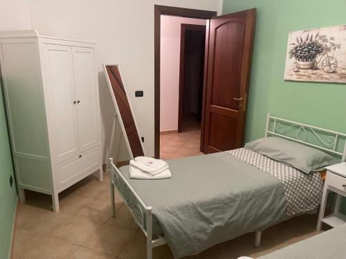 a small bedroom with a bed and a door at VILLA PATTY ASSISI con SPA in Assisi