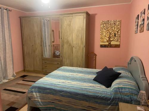 a bedroom with a bed and a cabinet in it at VILLA PATTY ASSISI con SPA in Assisi