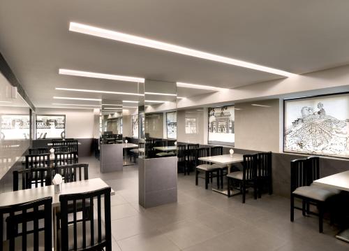 特里凡得琅Ariya Nivaas A Vegetarian Hotel的餐厅里有桌椅的餐厅