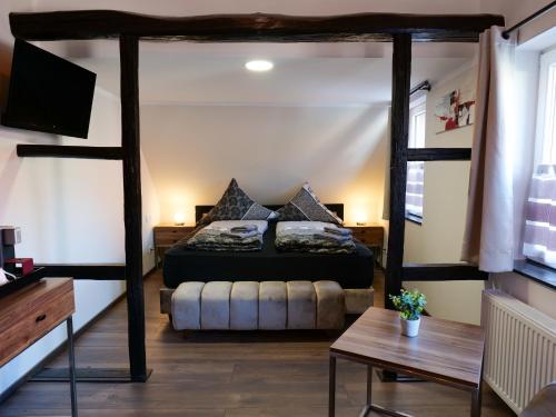 a bedroom with a four poster bed in a room at Haus Boutique in Bad Salzuflen