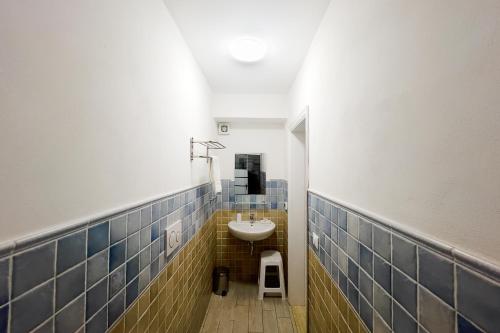 a bathroom with a sink and a stool in it at Residenza Portoferraio in Portoferraio