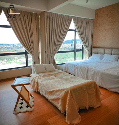 a bedroom with two beds and a large window at 1 min to Seaview & Sunrise Heart of Kuantan in Kuantan